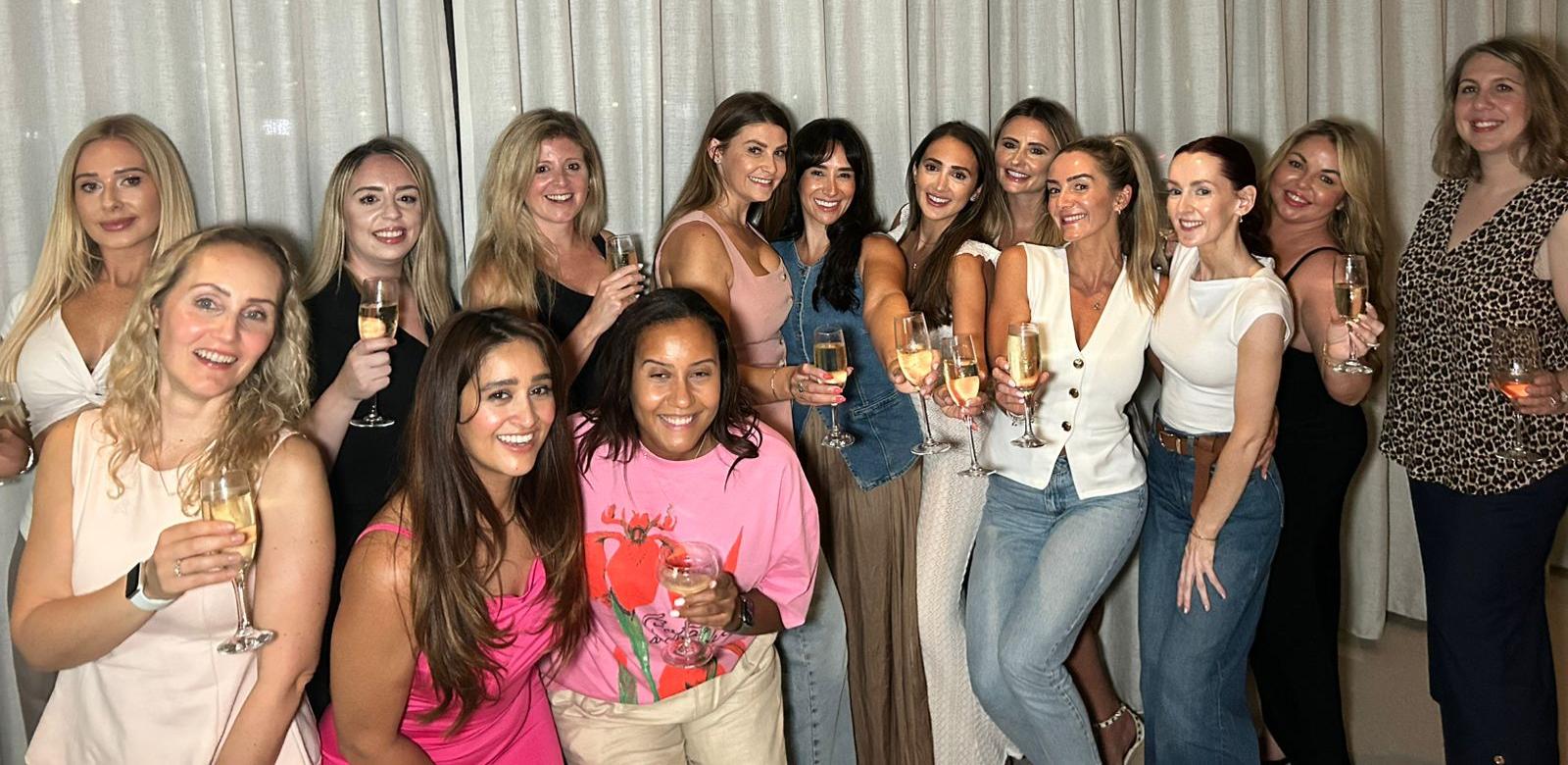 Team celebrating together holding champagne glasses