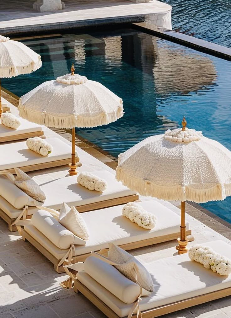 Boho umbrellas beside a pool